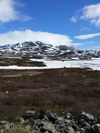 Scenic view of snowcapped mountain against cloudy sky