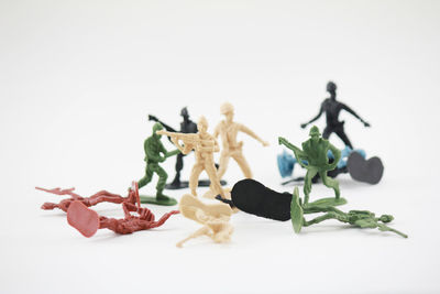Close-up of plastic toys over white background