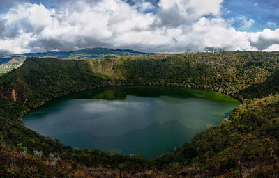 Scenic view of lake surrounded by trees against sky