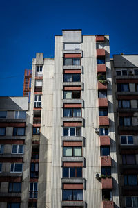 Low angle view of buildings against clear blue sky