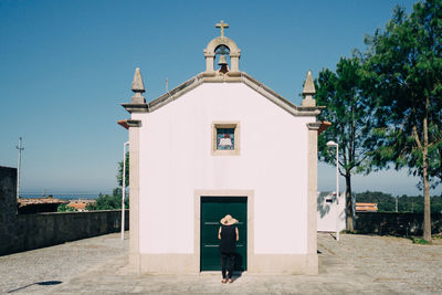 Woman standing in front of church