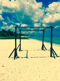 Scenic view of beach against cloudy sky