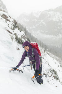 Woman tired while ice climbing sherman near lake city, colorado