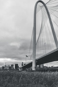 View of suspension bridge against cloudy sky