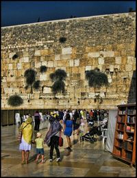 People standing in front of historic building