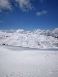 Scenic view of snowcapped mountains against sky