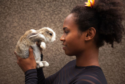 Young woman holding rabbit