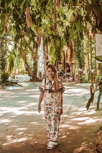 Full length of woman standing on roadside