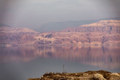 Scenic view of lake and mountains against sky