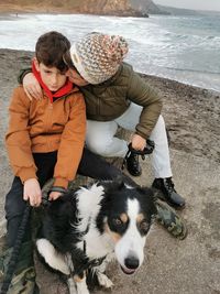 Dog and people on sea shore