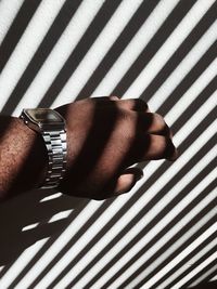 Close-up of hand on tiled floor