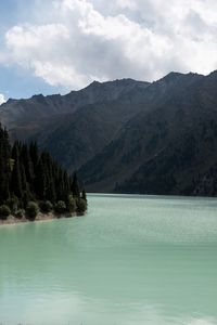 Scenic view of lake and mountains against sky