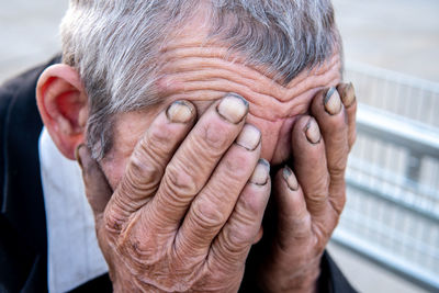 Close-up portrait of man with hands