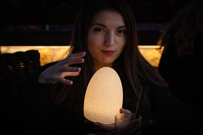 Girl with a night lamp in her hands.