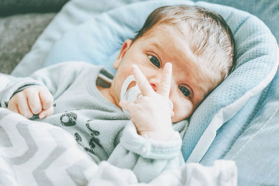 Portrait of baby girl lying on bed