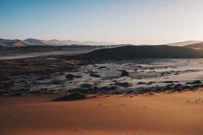 Scenic view of mountains against clear sky during sunset