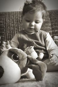 Close-up of cute baby girl sitting at home