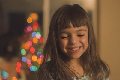 Close-up of smiling girl with eyes closed