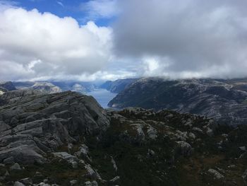 Scenic view of mountains against cloudy sky