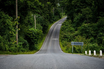 Road amidst trees in forest