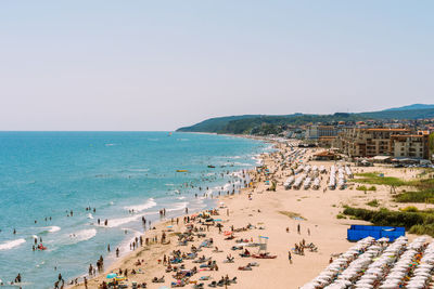 High angle view of people on beach against clear sky