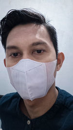 Close-up portrait of man covering face