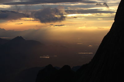 Scenic view of silhouette mountains against sky at sunset