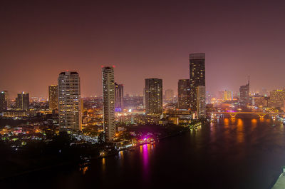 High angle view of illuminated cityscape against clear sky