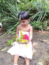 Full length of woman standing by flowering plants