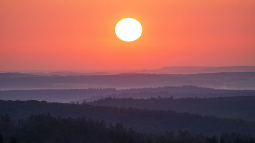 The sun rises over the mountain layers of the black forest