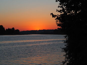 Scenic view of lake against orange sky