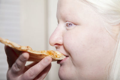 Close-up portrait of cute baby eating food