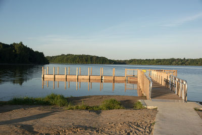 Wooden pier on lake against sky