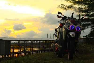 Train on field against sky during sunset