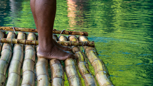 Punting down a river on a bamboo raft