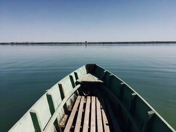 Pier over sea against clear blue sky