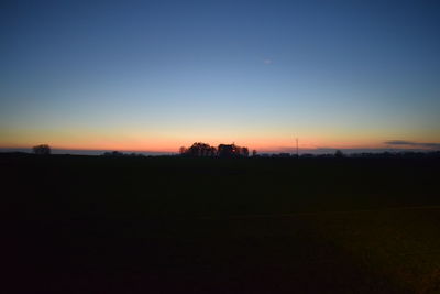 Scenic view of silhouette landscape against clear sky during sunset