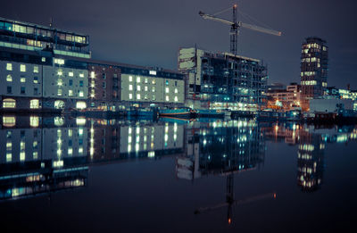 Reflection of buildings in city at night