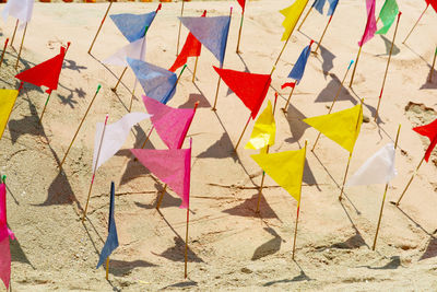 Close-up of multi colored umbrellas on sand