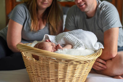 Family sitting on bed at home