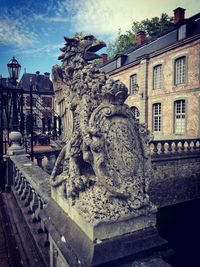 Statue of fountain against building in city