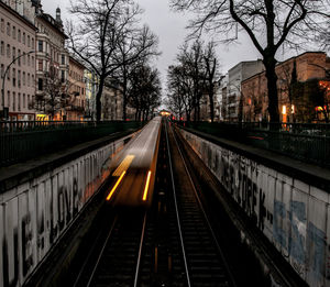 Railroad tracks in city at night