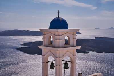 Anastasis church with its blue dome and tower in imerovigli village, santorini, greece