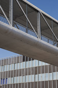 Low angle view of modern building against clear blue sky