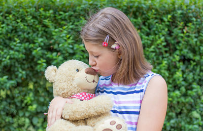 Girl looking away while holding toy