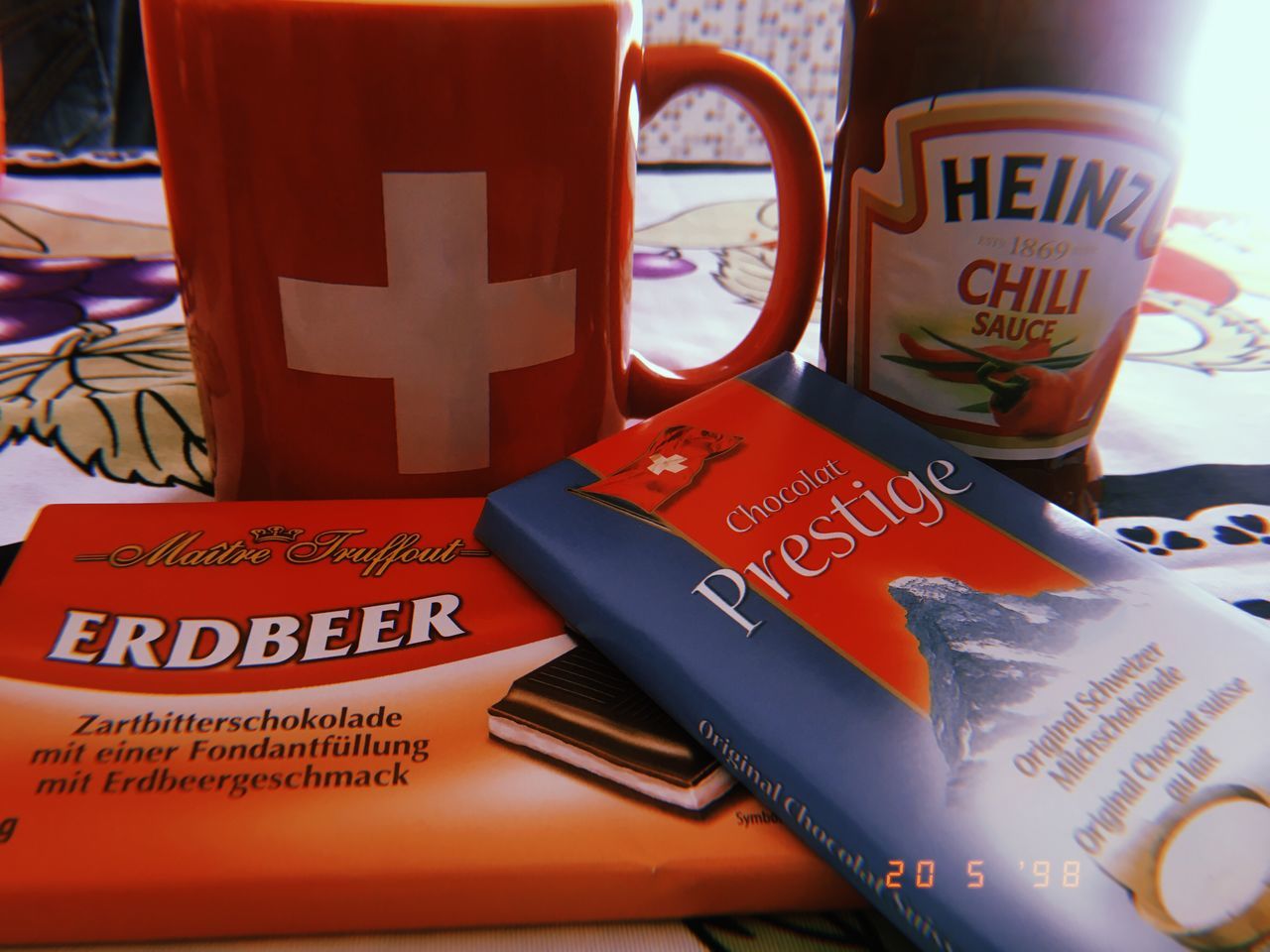 text, western script, communication, close-up, still life, indoors, no people, table, cup, sign, paper, red, non-western script, focus on foreground, script, message, capital letter, information, mug, day