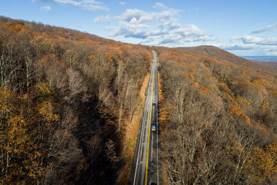 Panoramic shot of road by landscape against sky