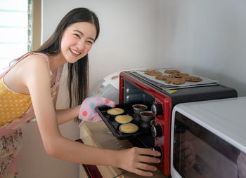 Young woman smiling while holding food