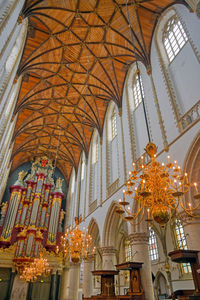 Low angle view of illuminated chandelier in building