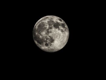 Low angle view of moon against clear sky at night